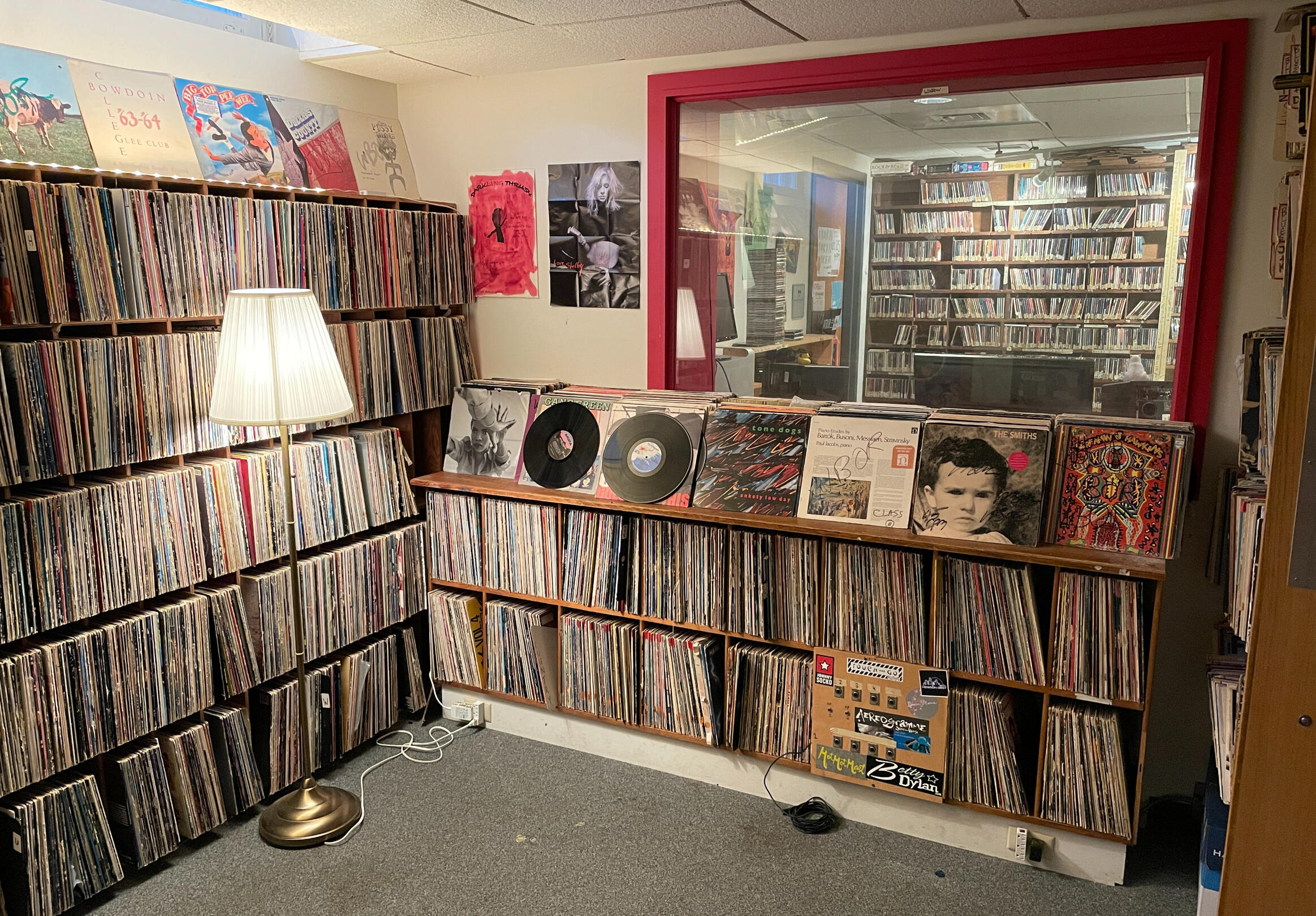 More vinyl records as well as a view into the recording studio through the glass wall