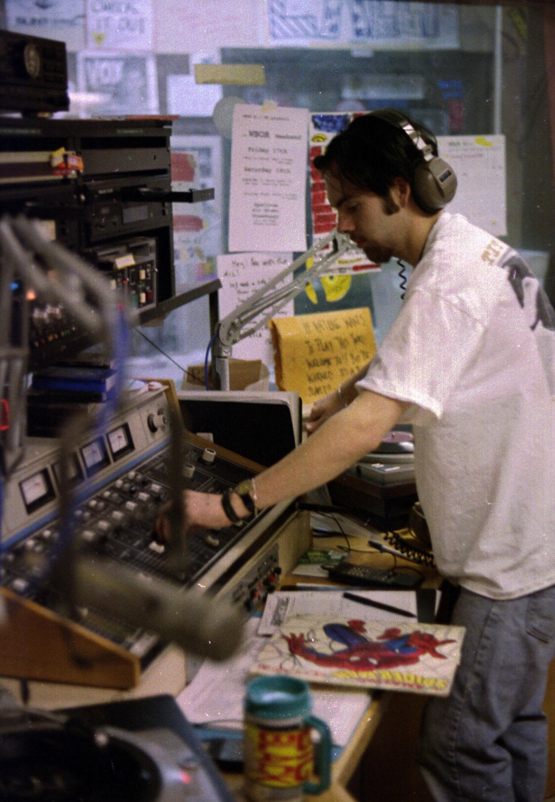 Student operating a radio audio console